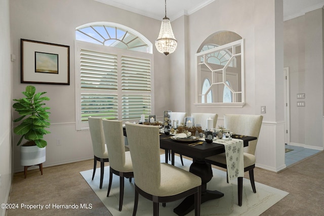 dining room with ornamental molding and an inviting chandelier