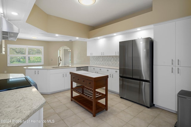 kitchen featuring a center island, white cabinets, sink, and stainless steel appliances