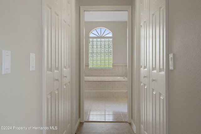 hallway featuring light tile patterned floors