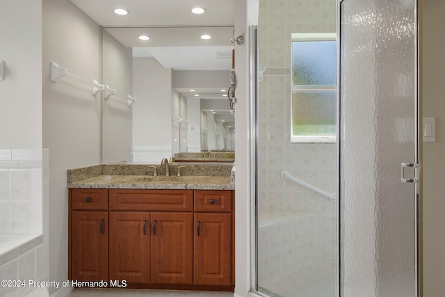 bathroom with independent shower and bath and vanity