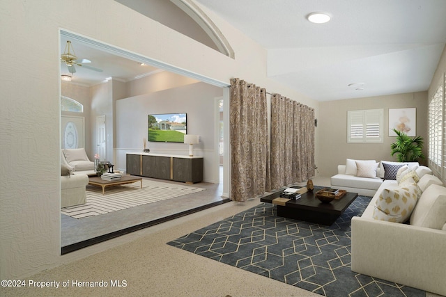 carpeted living room with a wealth of natural light, ceiling fan, and ornamental molding