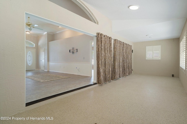 spare room featuring ceiling fan and crown molding