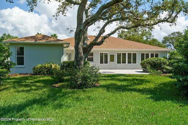 rear view of house with a lawn