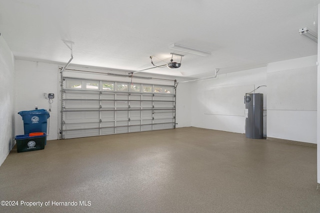 garage featuring water heater and a garage door opener