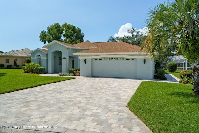 view of front of property with a garage and a front lawn