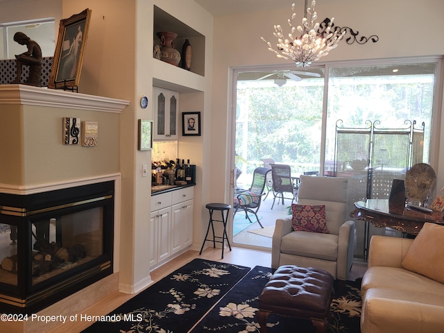 living room with light wood-type flooring and an inviting chandelier