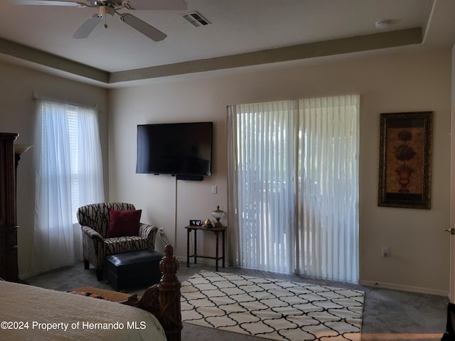 carpeted living room with ceiling fan