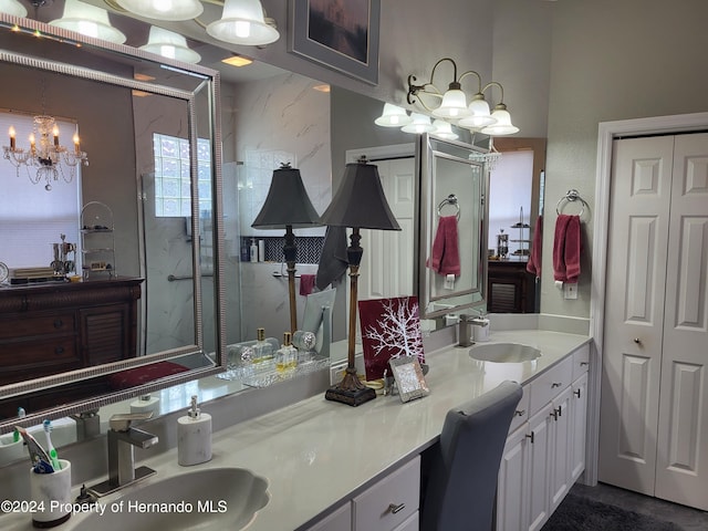 bathroom featuring walk in shower, vanity, and an inviting chandelier