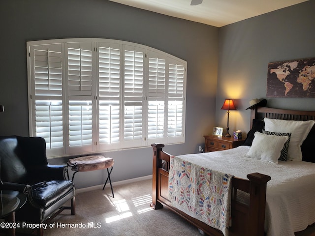 bedroom with ceiling fan and carpet floors