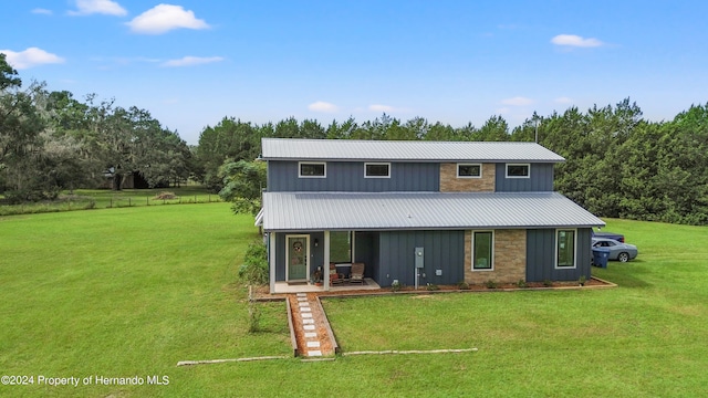 view of property with covered porch and a front yard