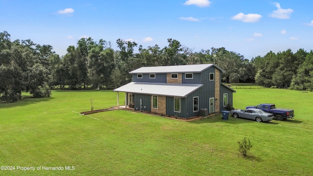 back of house with a lawn