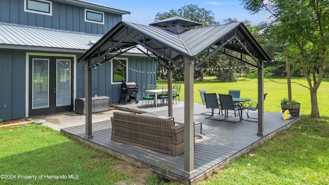 deck featuring a lawn, area for grilling, a gazebo, and french doors