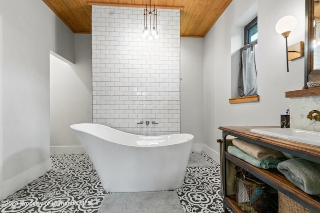 bathroom featuring a bathing tub, vanity, tile patterned floors, and wooden ceiling