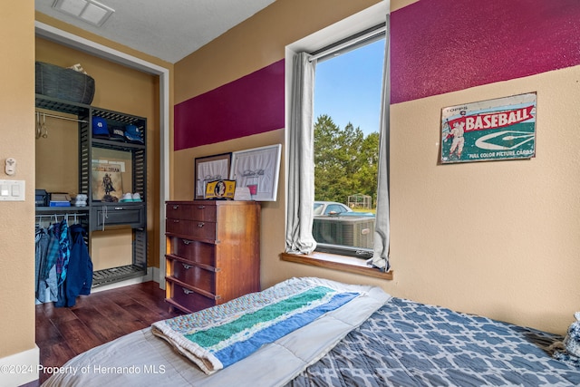 bedroom with a closet and dark hardwood / wood-style floors