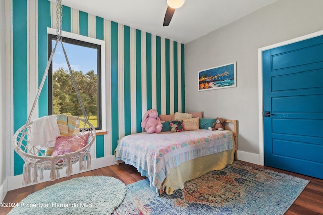 bedroom with dark hardwood / wood-style floors and ceiling fan