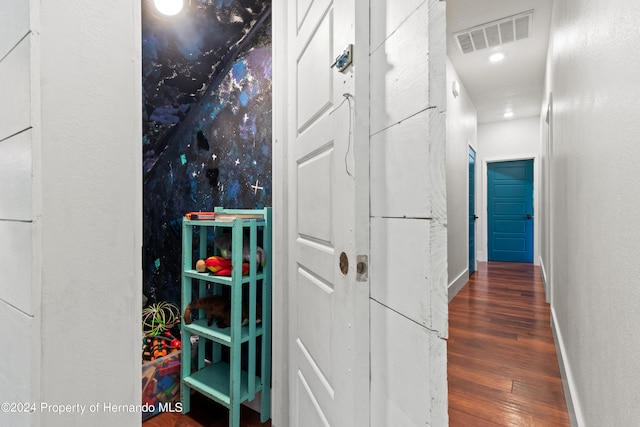 corridor with dark hardwood / wood-style flooring