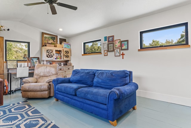 living room with hardwood / wood-style floors, lofted ceiling, and ceiling fan