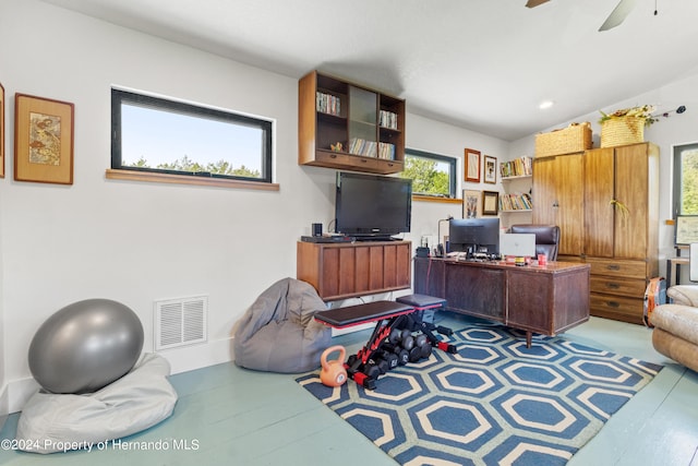 home office with hardwood / wood-style floors and ceiling fan