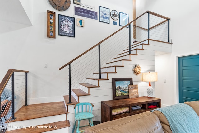 staircase with a towering ceiling