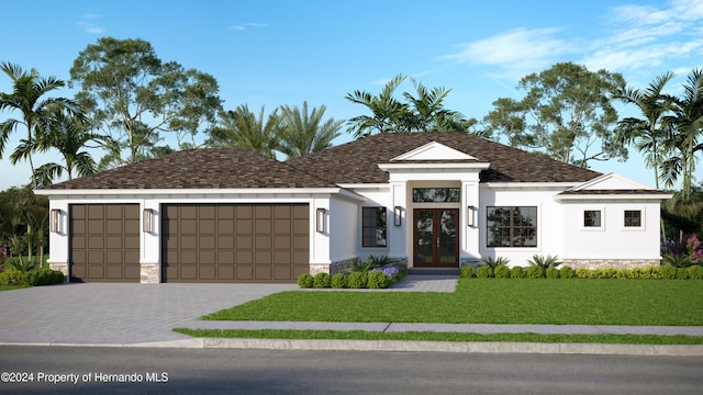 view of front facade featuring a front yard, french doors, and a garage