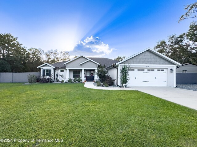 view of front of property with a front lawn and a garage