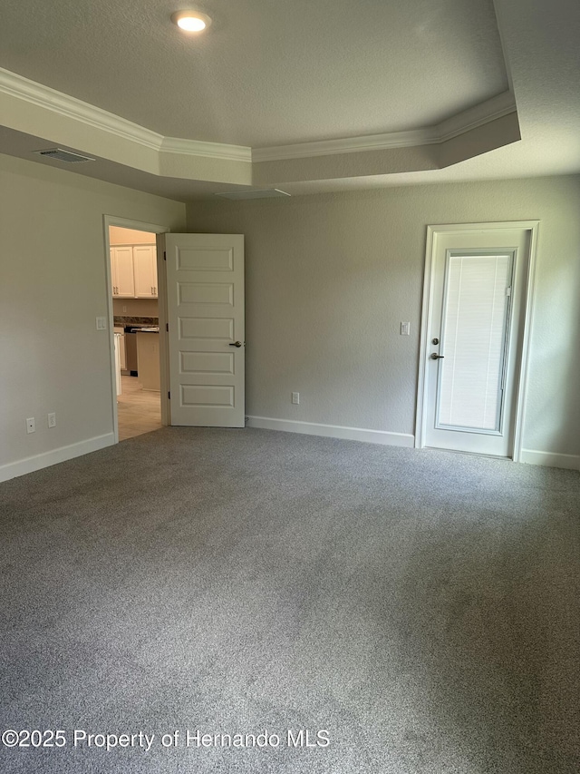 interior space featuring visible vents, a textured ceiling, crown molding, and carpet floors