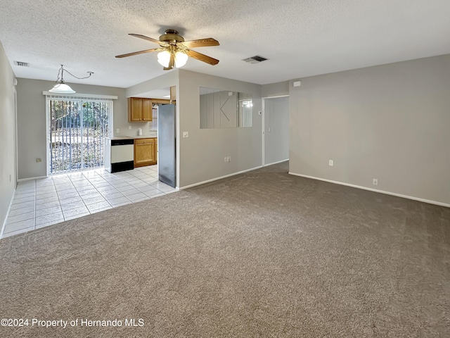 unfurnished living room with a textured ceiling, light colored carpet, and ceiling fan