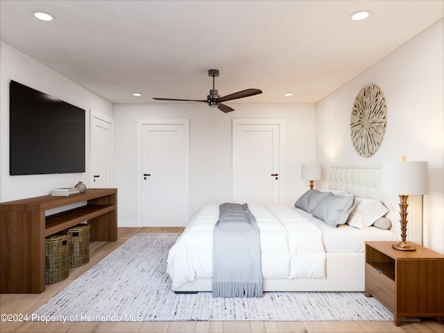 bedroom with ceiling fan and light hardwood / wood-style flooring