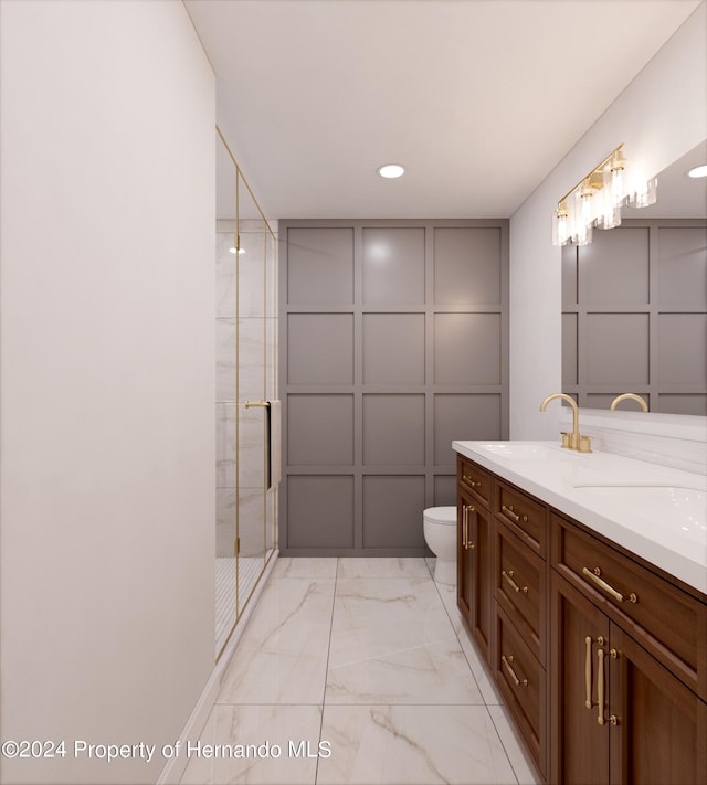 bathroom featuring vanity, toilet, and an enclosed shower