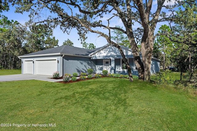 view of front facade featuring a garage and a front lawn