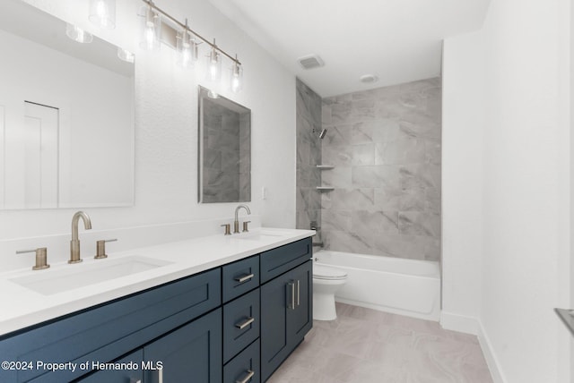 full bathroom with tiled shower / bath, toilet, and vanity