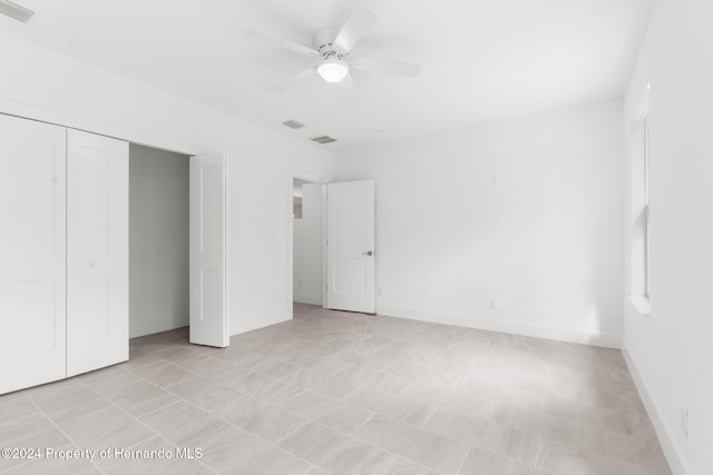 unfurnished bedroom featuring a closet and ceiling fan