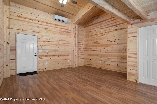 unfurnished room featuring wood walls, wood ceiling, and beam ceiling