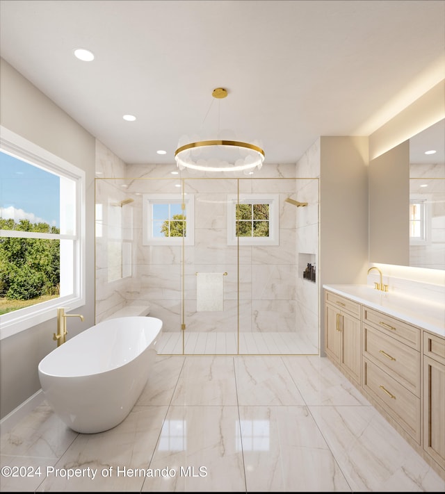 bathroom with vanity and shower with separate bathtub