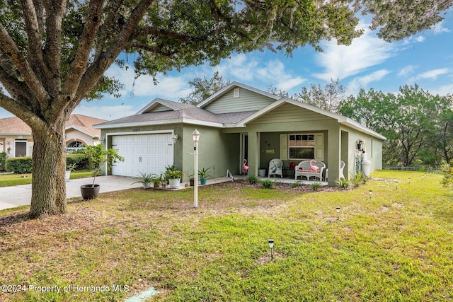 single story home with a front yard, covered porch, and a garage