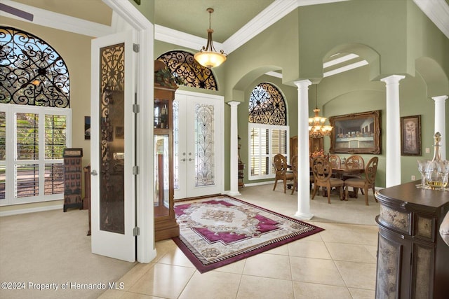 foyer entrance featuring a wealth of natural light, light tile patterned floors, and a high ceiling