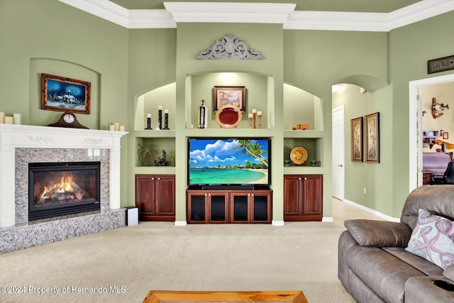 living room featuring built in features, ornamental molding, carpet flooring, a premium fireplace, and a high ceiling