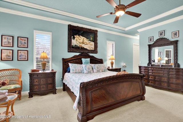 carpeted bedroom with ceiling fan and ornamental molding