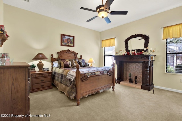 bedroom featuring light carpet and ceiling fan