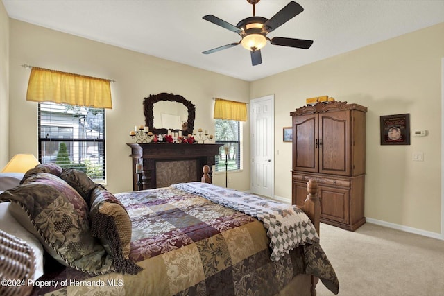 bedroom featuring light colored carpet and ceiling fan