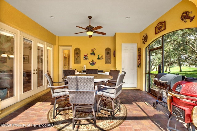 sunroom / solarium with french doors and ceiling fan