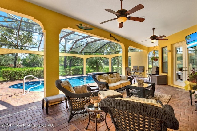 sunroom featuring ceiling fan and a swimming pool