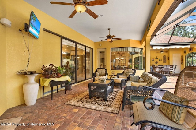 view of patio featuring a lanai, outdoor lounge area, and ceiling fan