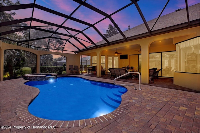 view of pool featuring an in ground hot tub, a patio area, ceiling fan, a lanai, and an outdoor hangout area