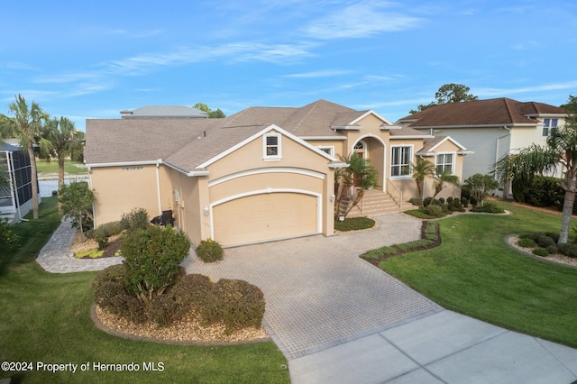 view of front of property featuring a front yard and a garage