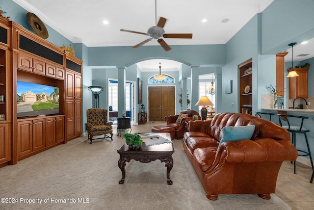 living room featuring ornamental molding, ceiling fan, sink, and light tile patterned flooring