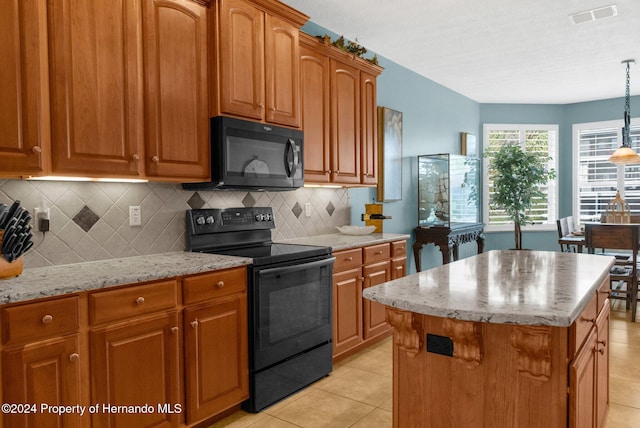 kitchen featuring light tile patterned flooring, black appliances, tasteful backsplash, a kitchen island, and pendant lighting