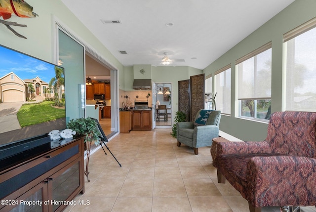 interior space with light tile patterned floors and ceiling fan