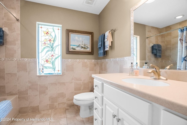 bathroom with tile walls, tile patterned flooring, vanity, and toilet