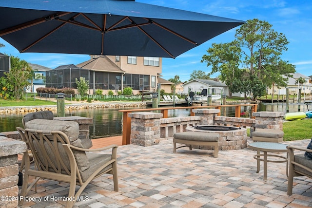 view of patio / terrace featuring a water view and an outdoor fire pit